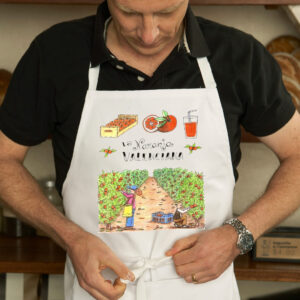 Delantal con un diseño artesanal dedicado a la naranja valenciana.